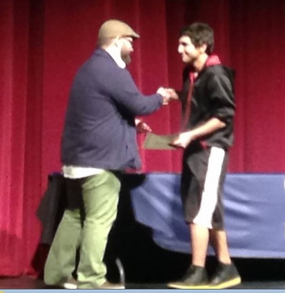 Jeremy Chuck DeAnda receives an award at Lit Fest on April 15th at Oswego East High School