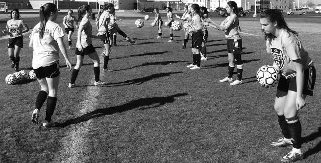 Girls’ Soccer warming up on Friday, March 11  practicing footwork along different types of touches on the soccer ball that could be beneficial in games.