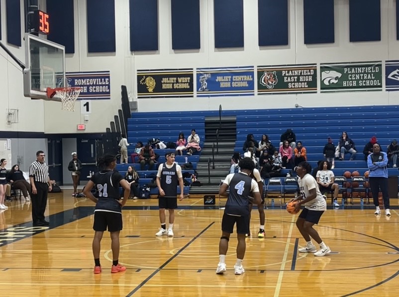 The boys basketball team playing on Blue and White night of this school year.